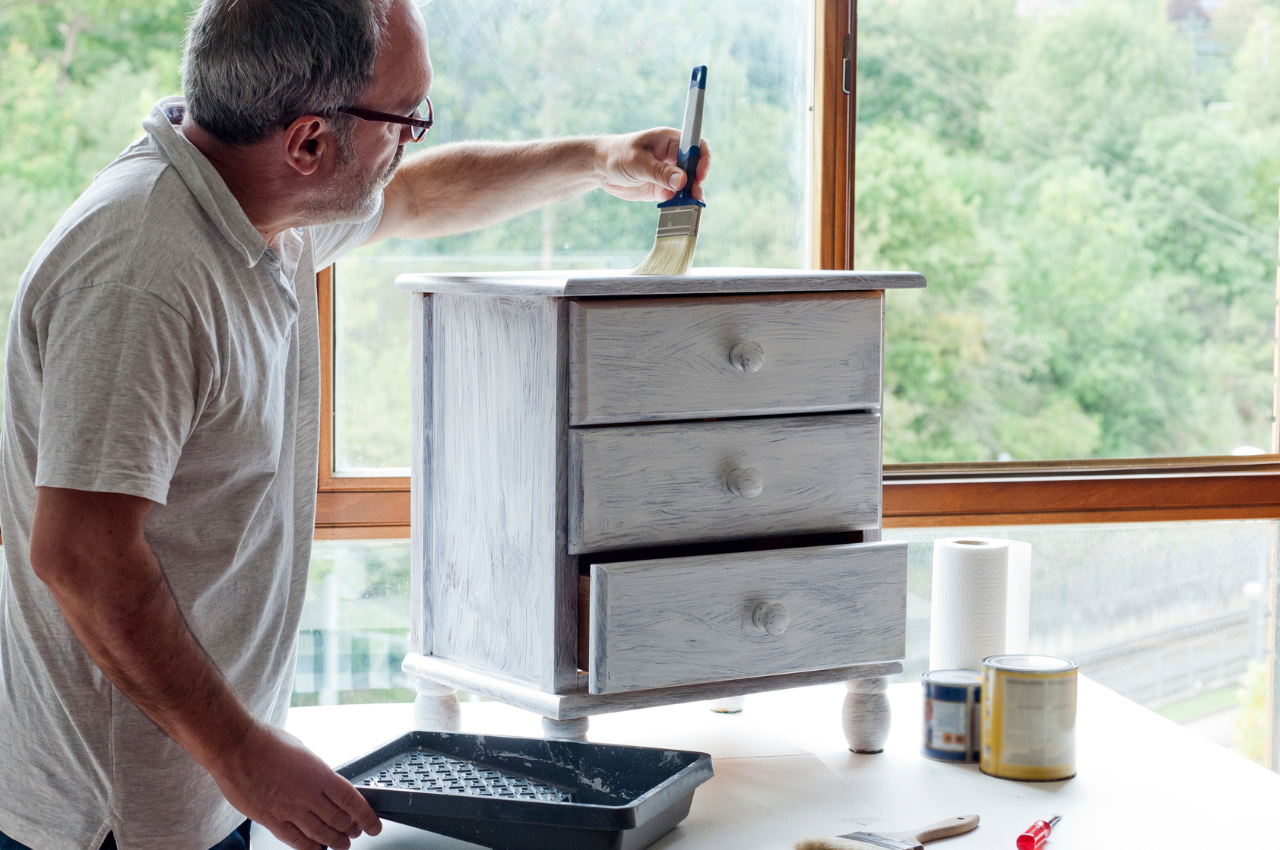 Man repainting furniture