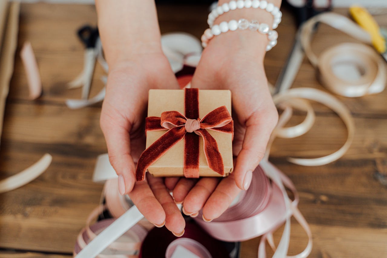 Person Holding a Small Gift Box - Gift Idea Under $100 For Every Occasion 